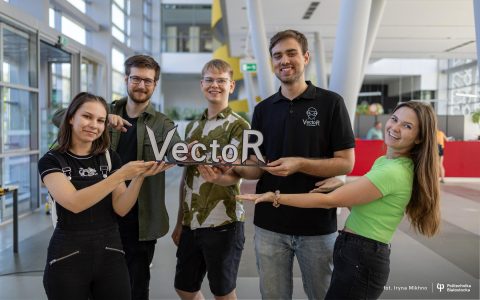 Młodzi ludzie trzymają w ręku napis Vector